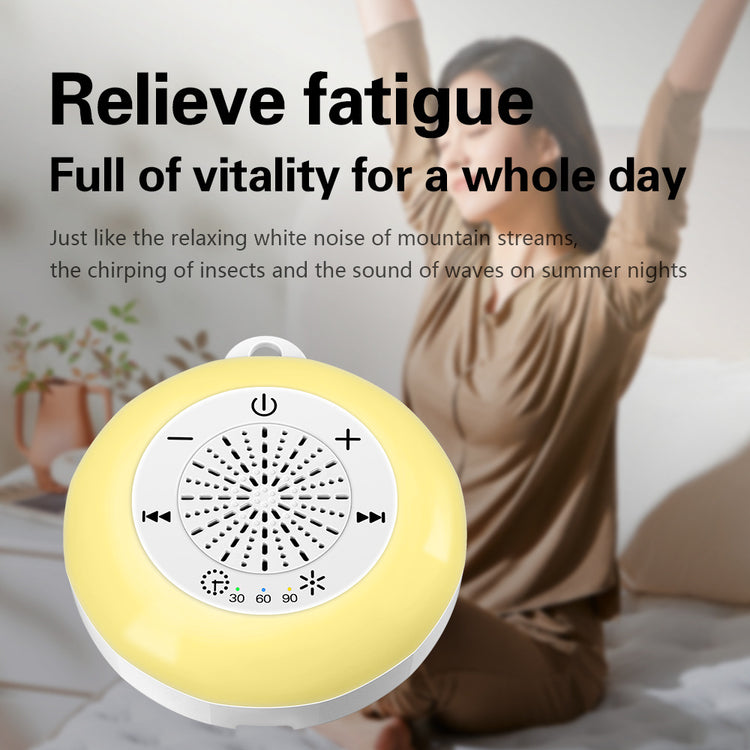 Round yellow and white portable white noise machine with timer buttons, in a bright bedroom